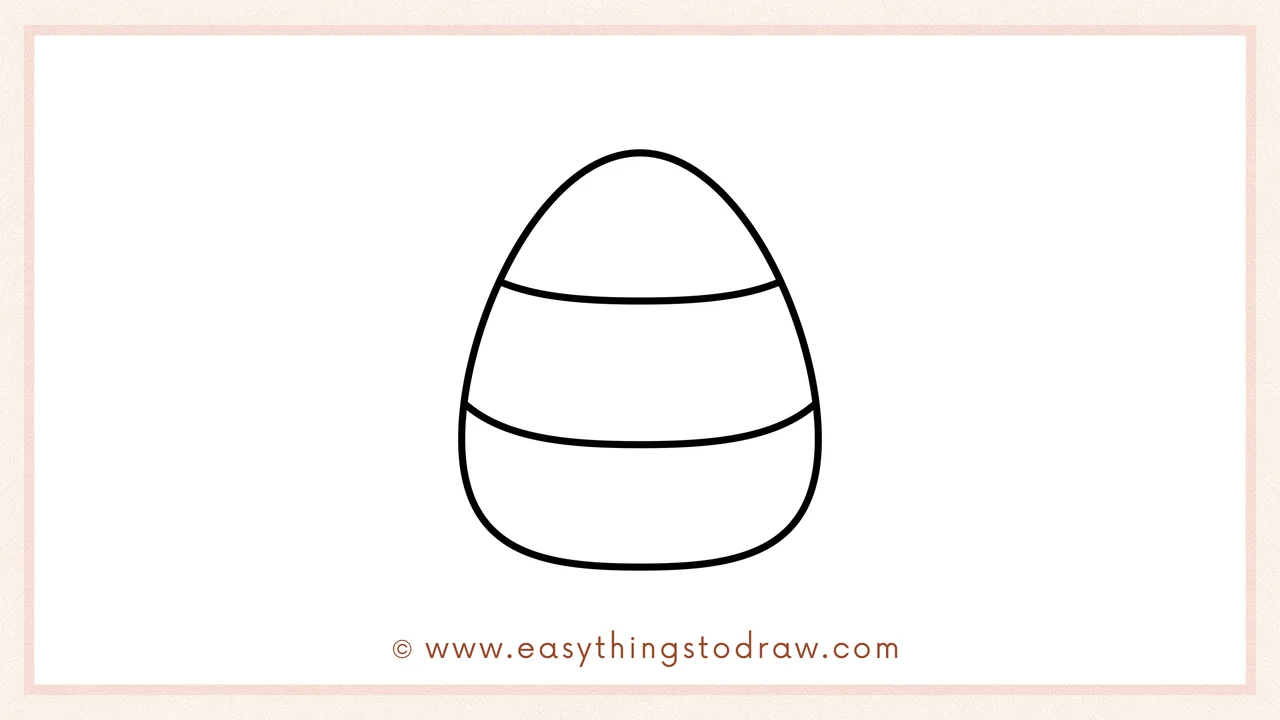 Step 5 of easy candy corn drawing steps – adding another curved line below the first to create the second color section.