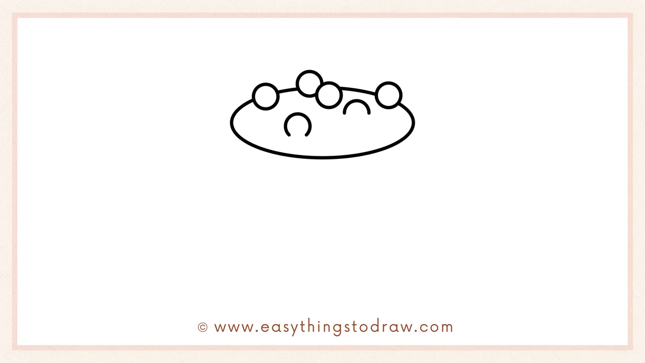Step 2 of drawing a cauldron – Connecting the bubbles with a large horizontal oval to form the cauldron's top rim.