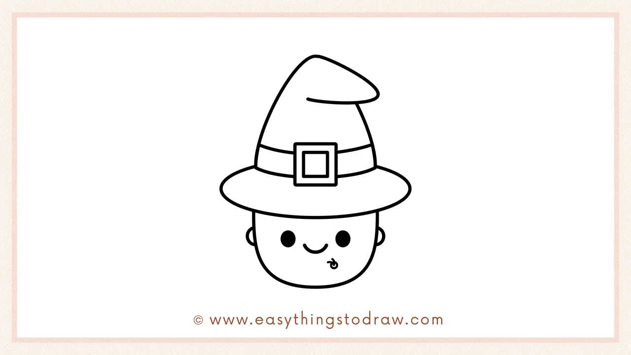 Step 5 of easy witch drawing steps – detailing the witch's face with two black dot eyes, a cute smile, and a swirl charm.