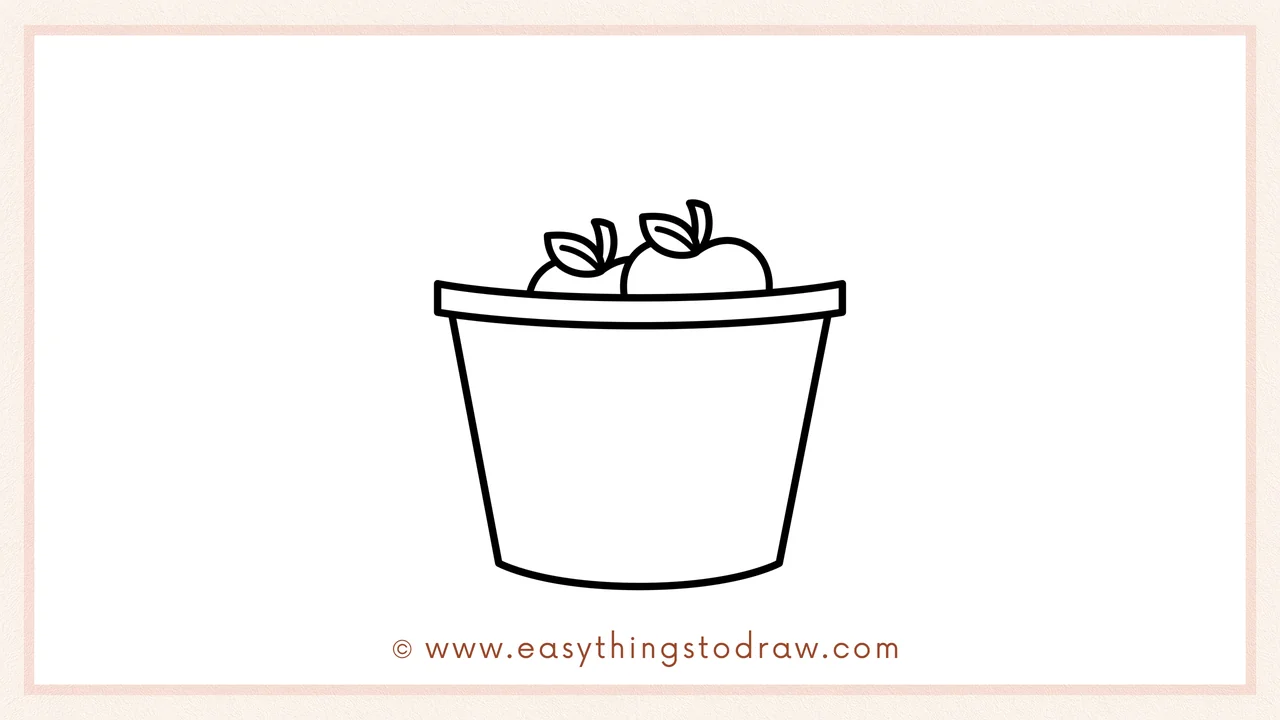 Step 3 of sketching a bucket of apples for beginners – Drawing two round apples with stems and leaves inside the rim.