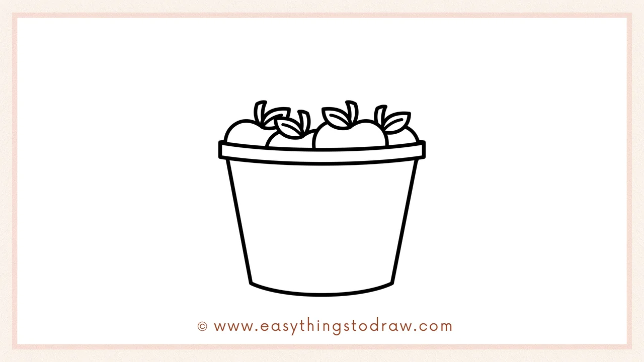 Step 4 of step-by-step bucket of apples sketch – Adding more round apples with leaves behind the first two to fill halfway.