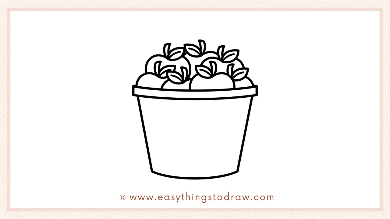 Step 5 of easy bucket of apples drawing steps – Filling the bucket to overflowing with more round apples and leaves.