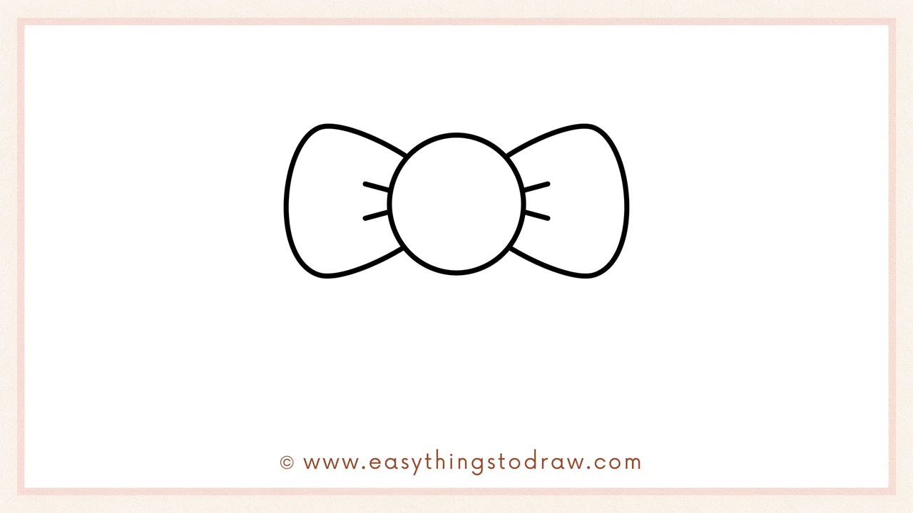 Step 3 of sketching a Christmas bow for beginners – Mirror the left loop by drawing an identical oval on the right side.