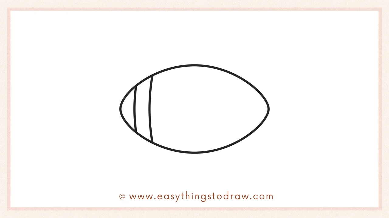 Step 2 of drawing a football – Adding two vertical curves on the left side for the first stripe.