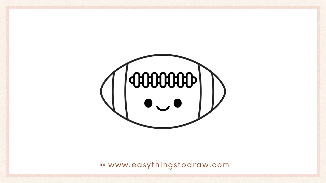 Step 6 of simple football drawing tutorial – Adding two round eyes and a smiling mouth to the football.