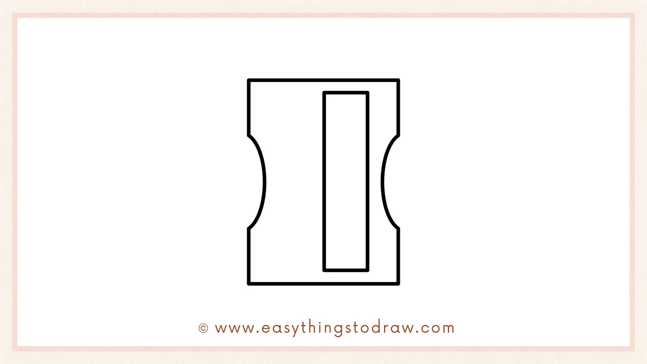 Step 3 of sketching a pencil sharpener for beginners – drawing a tall, narrow rectangle in the center for the blade housing.