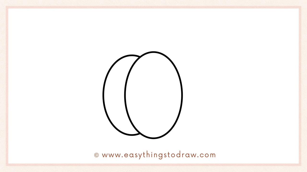 Step 2 of drawing a cute pumpkin in steps – adding a slightly overlapping oval to the left of the center section.