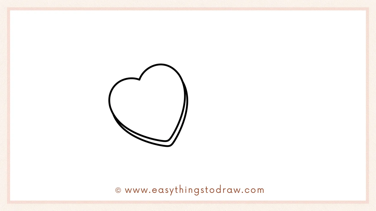 Step 2 of drawing a candy heart – Add a smaller heart inside the first one to create the candy edge.