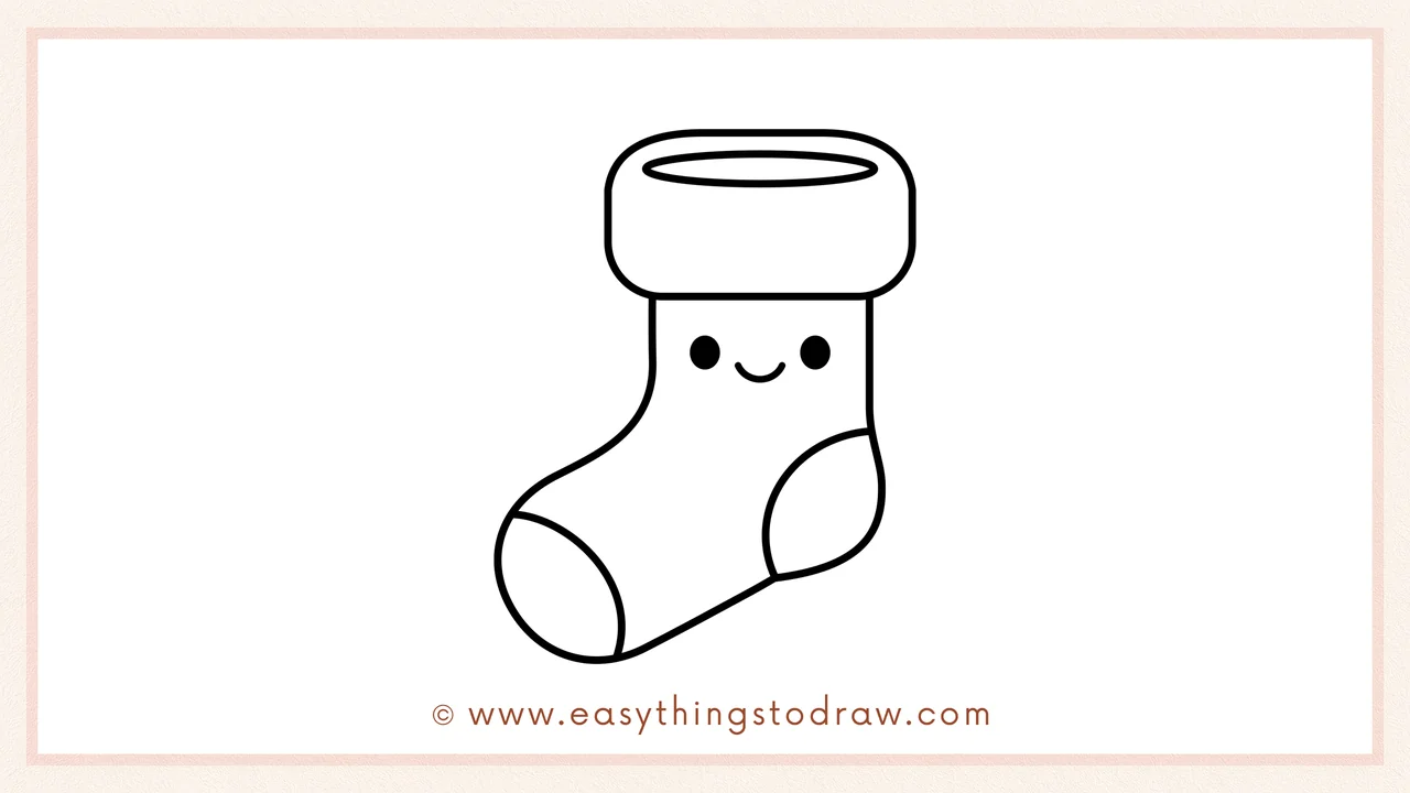 Step 6 of a simple Christmas stocking drawing tutorial – adding two small dots for eyes and a happy smile.