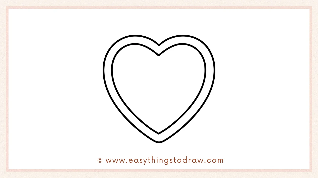 Step 2 of drawing a Valentine's Day box of chocolates – Adding a smaller heart inside the first one to create the box's border.