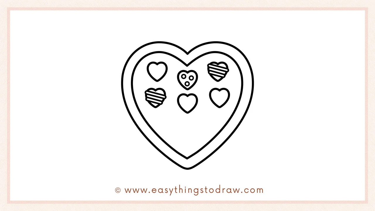 Step 4 of a step-by-step Valentine's Day box of chocolates sketch – Adding more assorted chocolates inside the heart to fill it up.