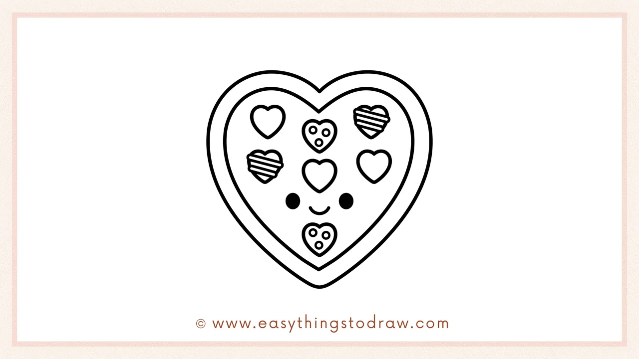 Step 6 of a simple Valentine's Day box of chocolates drawing tutorial – Adding two dot eyes and a smile to give the box a cute face.