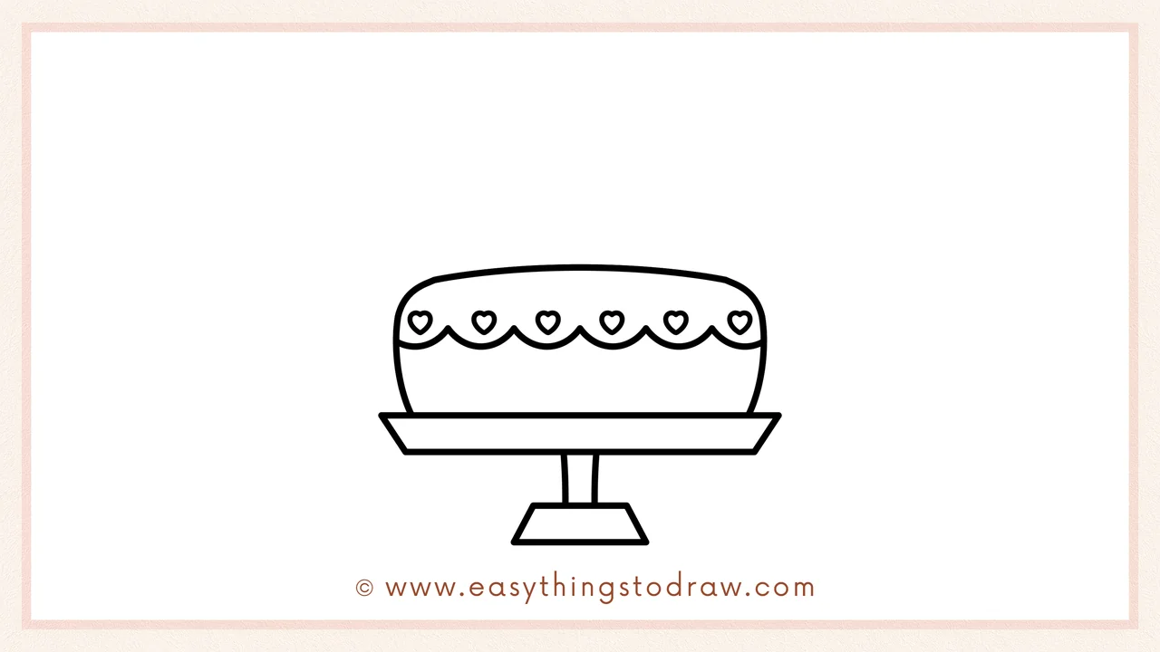 Step 2 of drawing a valentines day cake – Adding a large rounded rectangle with a scalloped line and hearts for the first tier.