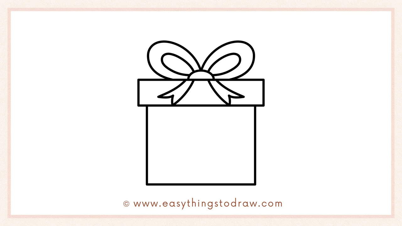 Step 4 of a step-by-step Valentine's Day Gift sketch – adding two flowing ribbon ends hanging down from the center of the bow.