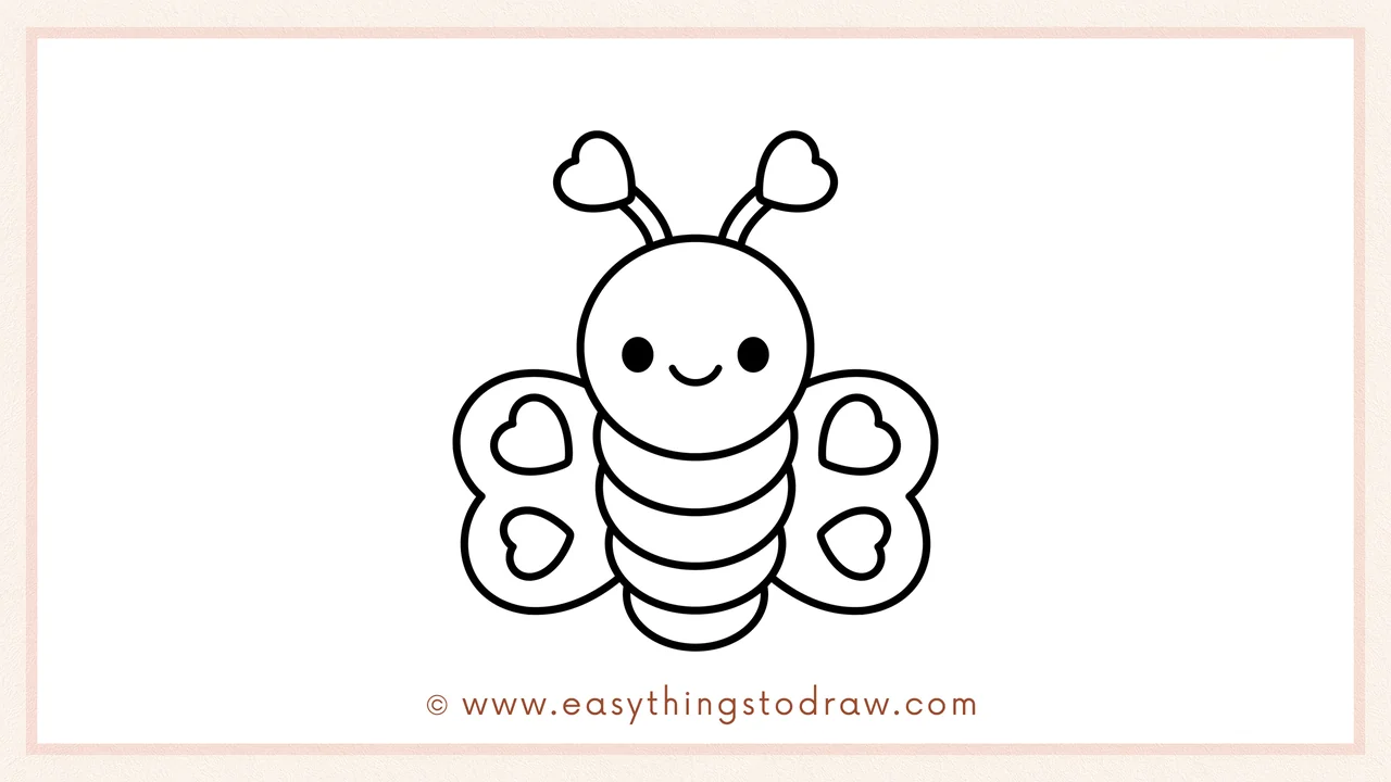 Step 6 of a simple love bug drawing tutorial – Two smaller hearts are added inside each wing for decoration.