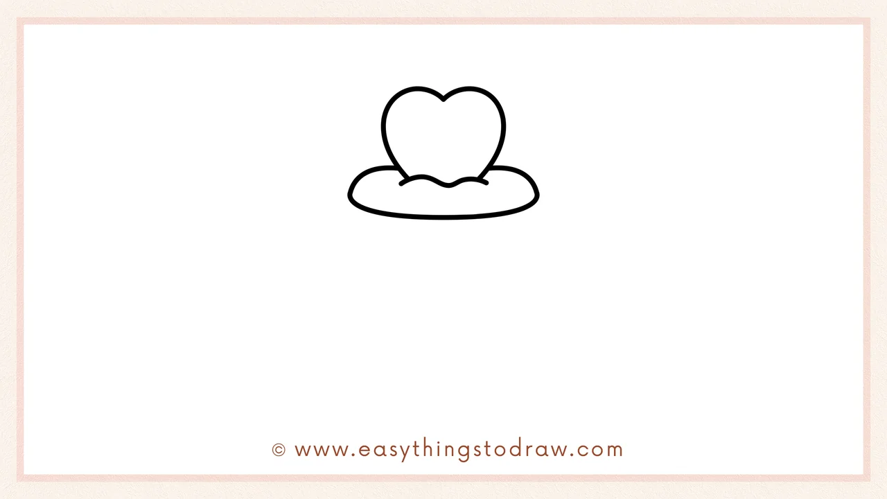 Step 2 of drawing a valentines cupcake – Sketching a fluffy, curved oval shape directly underneath the heart for the first layer of frosting.