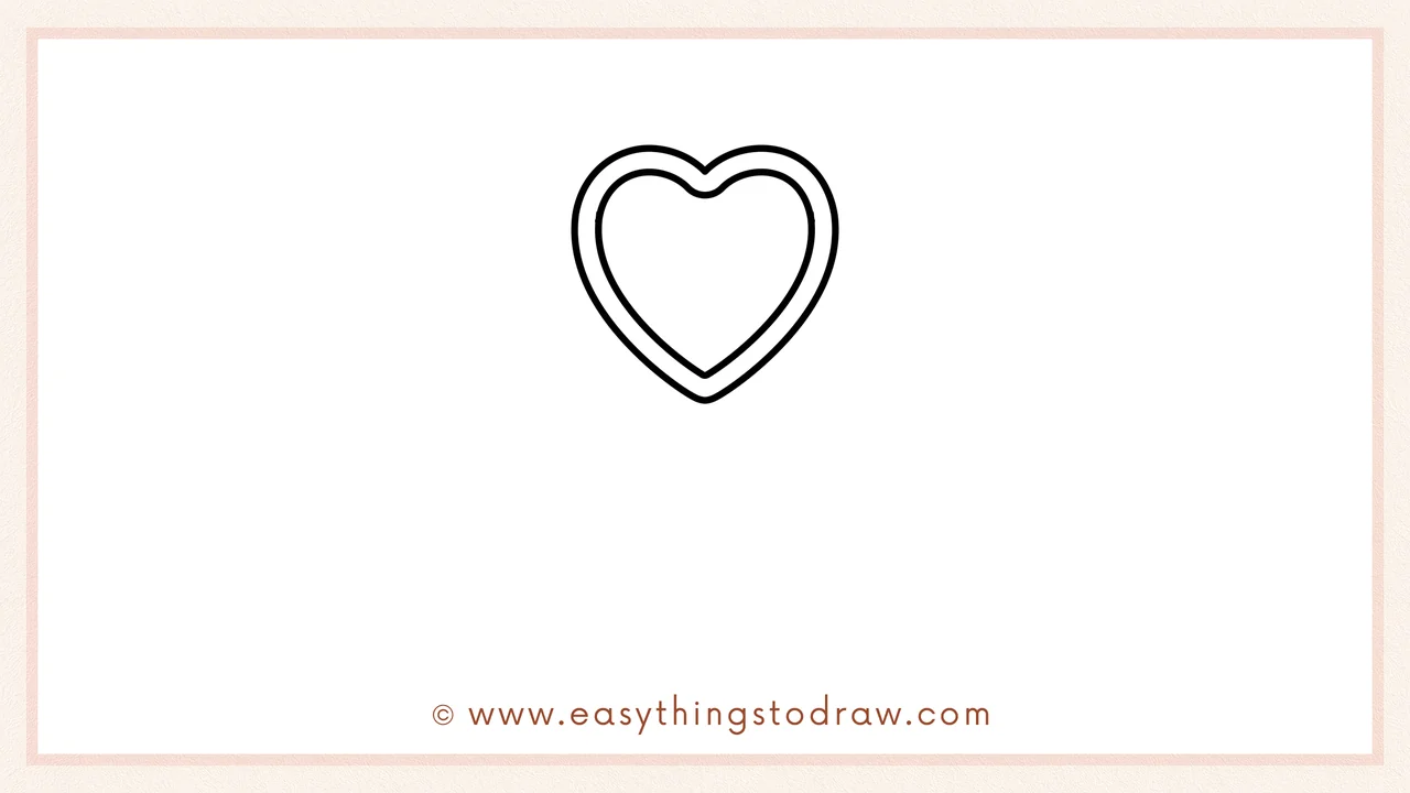 Step 2 of drawing a valentines day lollipop – Adding a second, larger heart shape around the first one to create a thick outline.