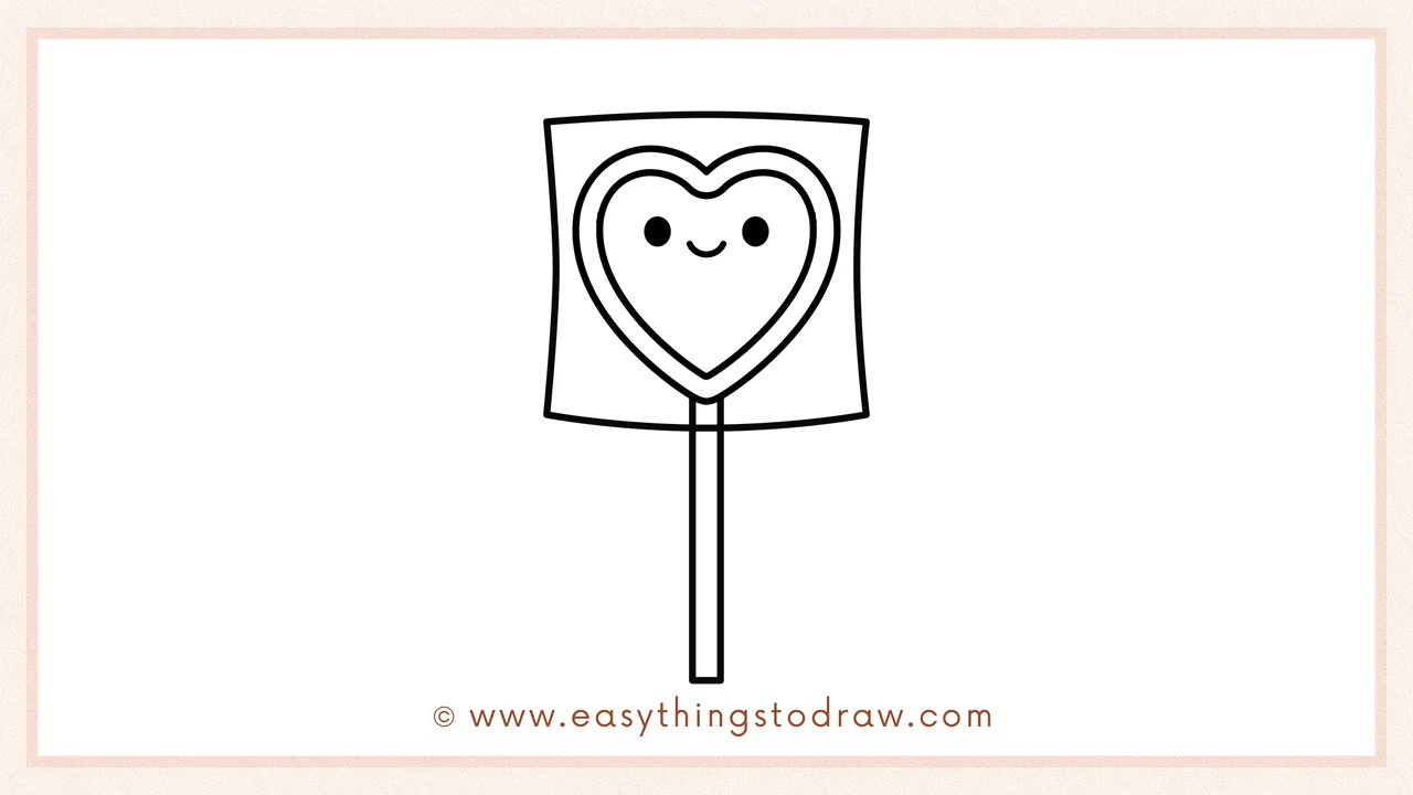 Step 6 of a simple valentines day lollipop drawing tutorial – Adding two small circles for eyes and a curved line for a smile on the heart.