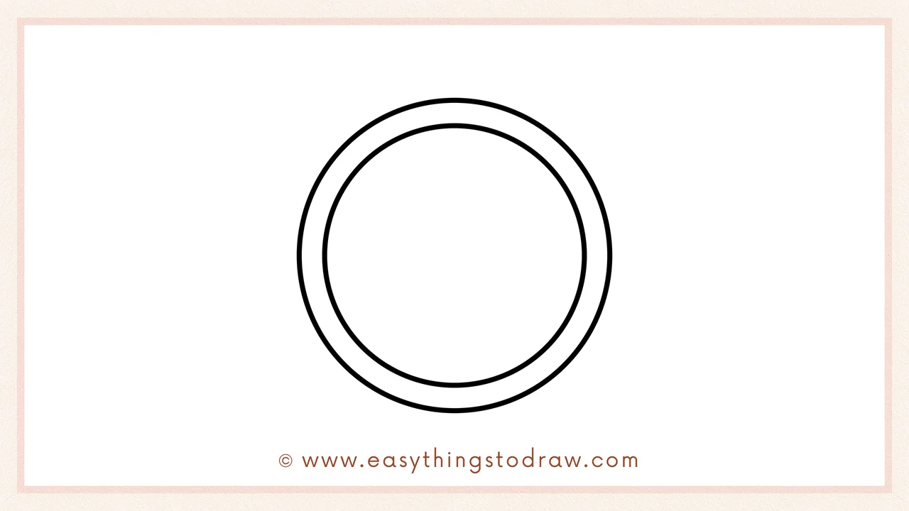 Step 2 of drawing a coin – Adding a smaller circle inside the first one to create the coin's raised rim.