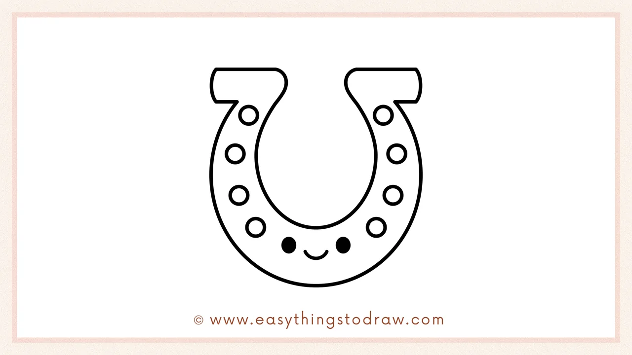 Step 6 of a simple horseshoe drawing tutorial – Adding two eyes and a smile to the center and coloring the drawing.