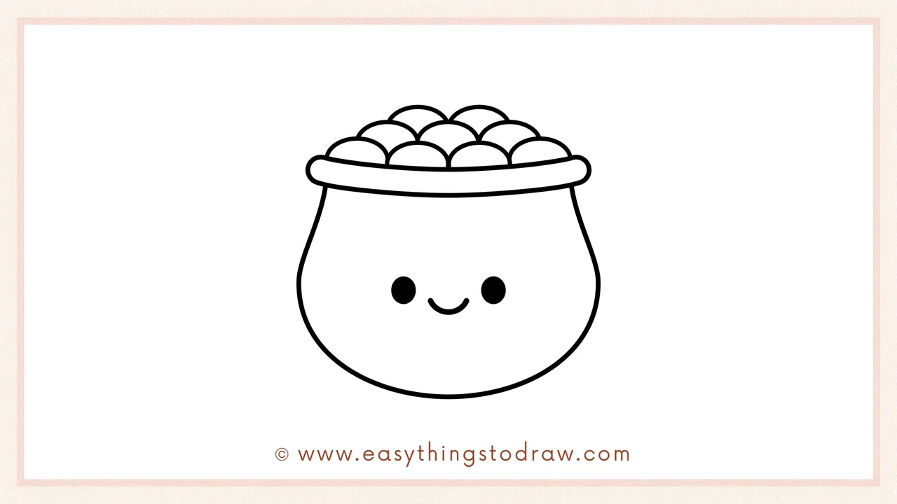 Step 6 of simple pot of gold drawing tutorial – Adding two oval eyes and a curved smile to the front of the pot to give it a happy face.