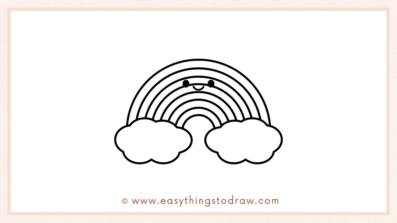 Step 6 of a simple rainbow drawing tutorial – Adding two dot eyes and a small smiling mouth to the rainbow to give it a cute face.