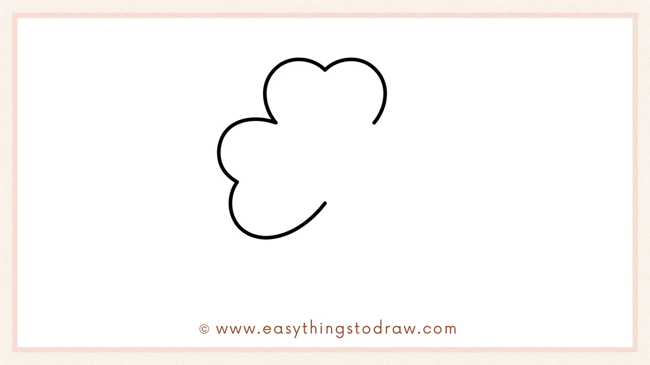 Step 2 of drawing a shamrock – adding the third leaf on the left side, pointing diagonally down.
