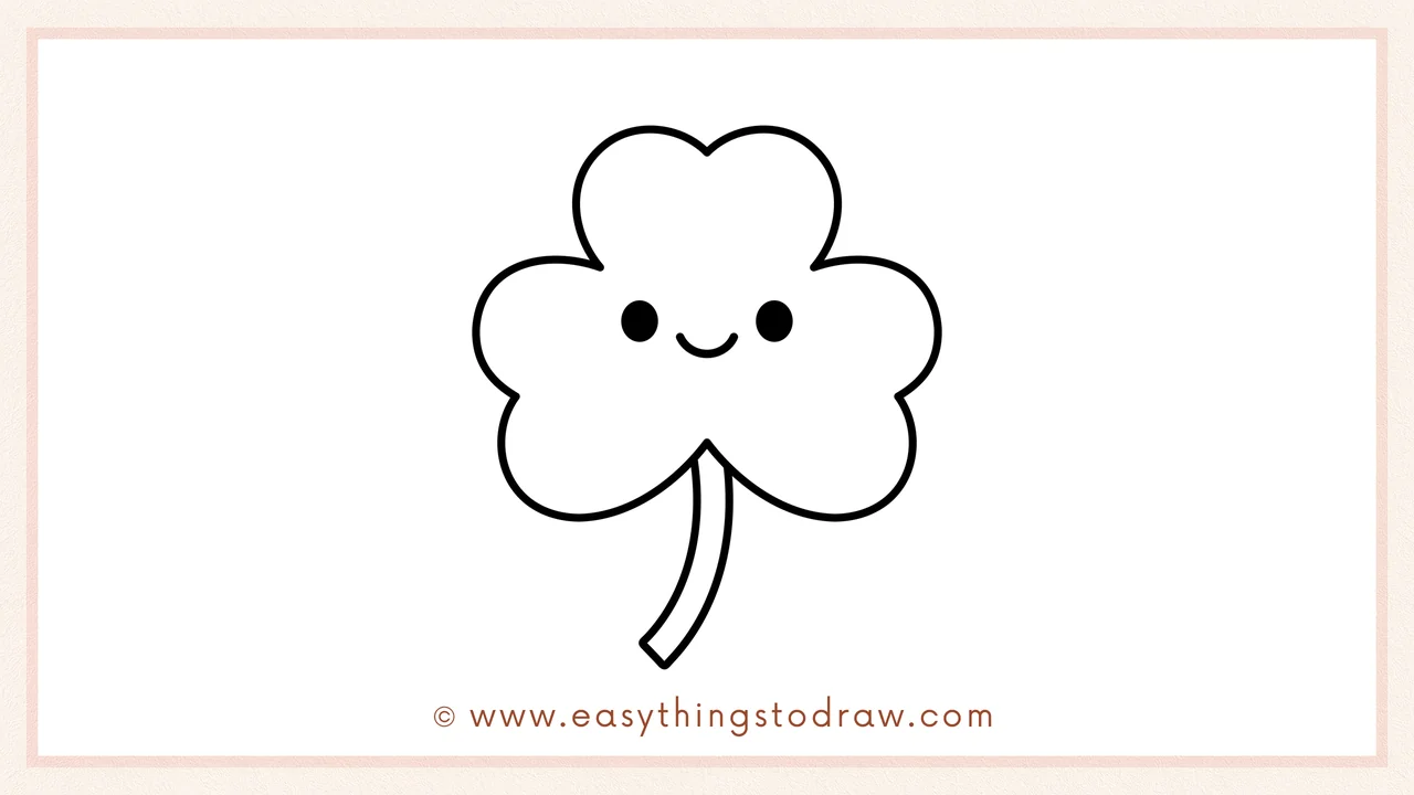Step 6 of simple shamrock drawing tutorial – adding two dots for eyes and a small curved smile.