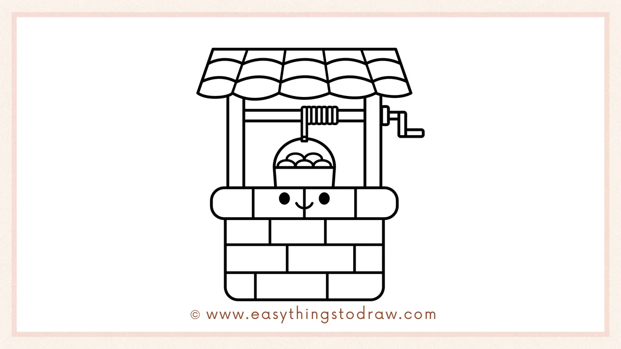 Step 6 of simple wishing well drawing tutorial – Give the well a friendly personality with two dot eyes and a smiling mouth.